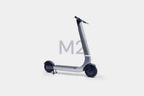 Silver scooter with 'M2' text on a white background