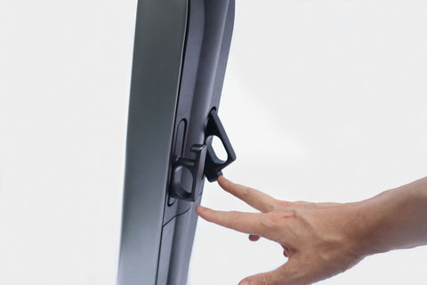 Hand rotating out Lock and Load feature on scooter.
