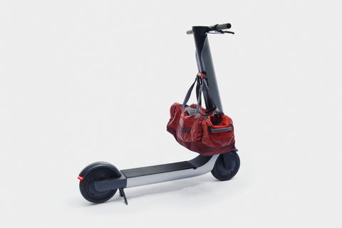 Scooter with a red bag on a white background